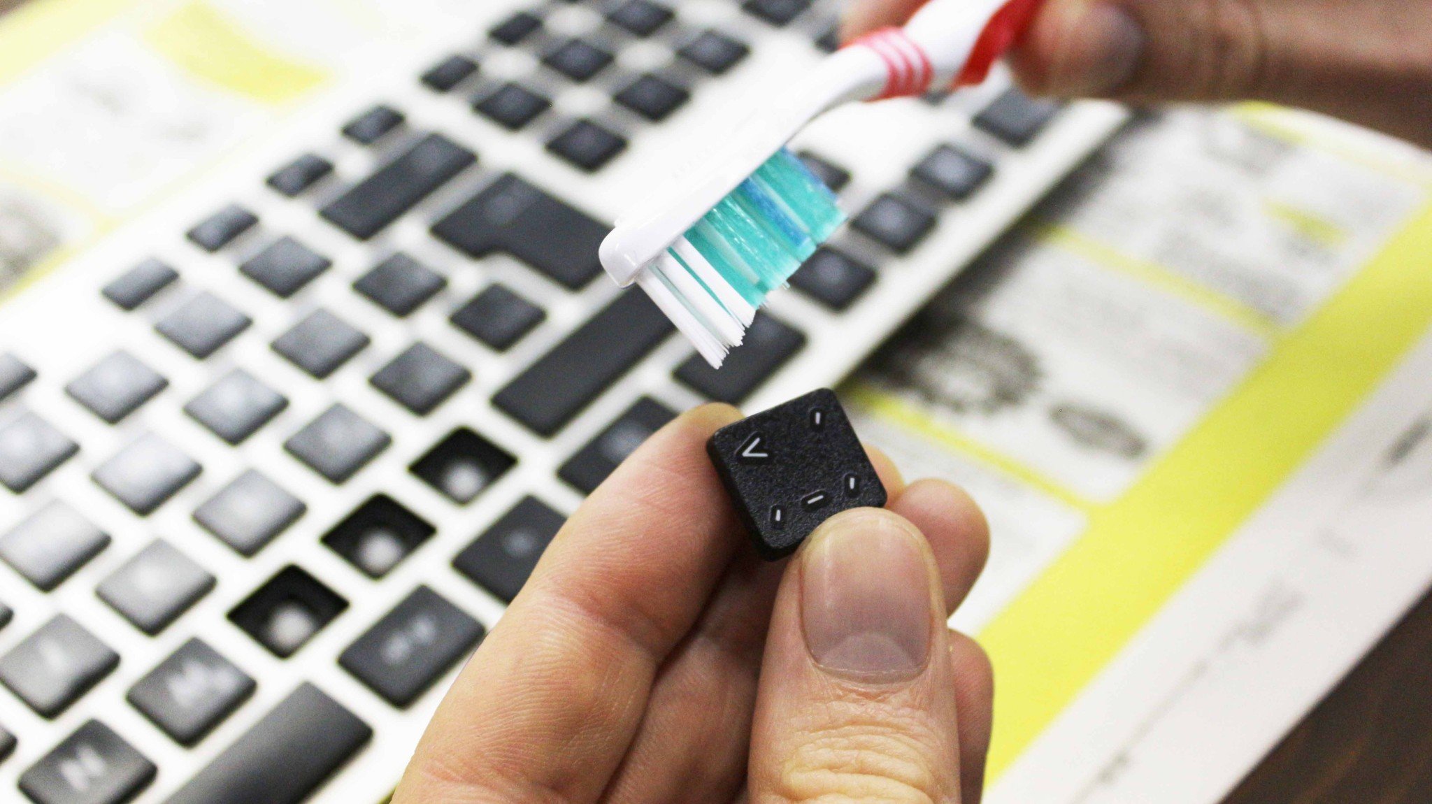 Scrub each keycap using a toothbrush and isopropyl alcohol.