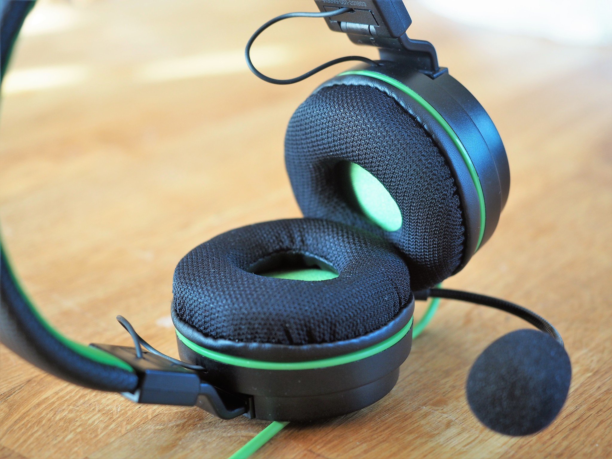 A pair of Snakebyte headphones lay on their side. 