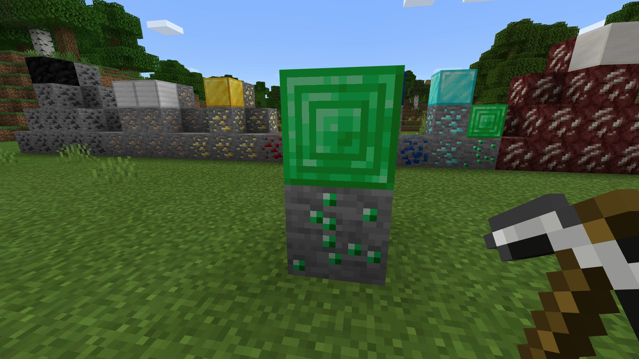Some emerald ore and an emerald block